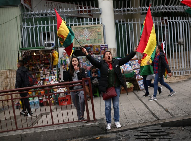 People celebrate after Bolivia's President Evo Morales announced his resignation in La Paz