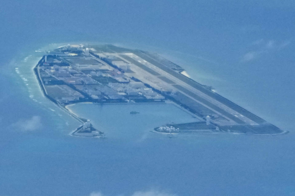 Chinese structures and buildings on the man-made Fiery Cross Reef at the disputed Spratlys group of islands in the South China Sea are seen on March 20, 2022. The Philippine government has summoned a senior Chinese diplomat in Manila to protest the harassment by the Chinese coast guard of a research vessel manned by Filipino and Taiwanese scientists in the disputed South China Sea, officials said Tuesday May 31, 2022. (AP Photo/Aaron Favila)