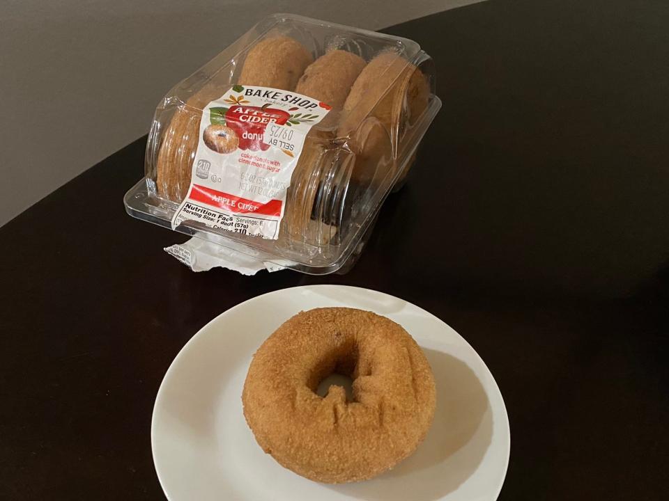 The Bake Shop apple-cider doughnuts on a table with one on a plate