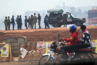 Security forces gather in Kampala, Uganda, Thursday, Jan. 14, 2021. Ugandans are voting in a presidential election tainted by widespread violence that some fear could escalate as security forces try to stop supporters of leading opposition challenger BobiWine from monitoring polling stations.(AP Photo/Jerome Delay)