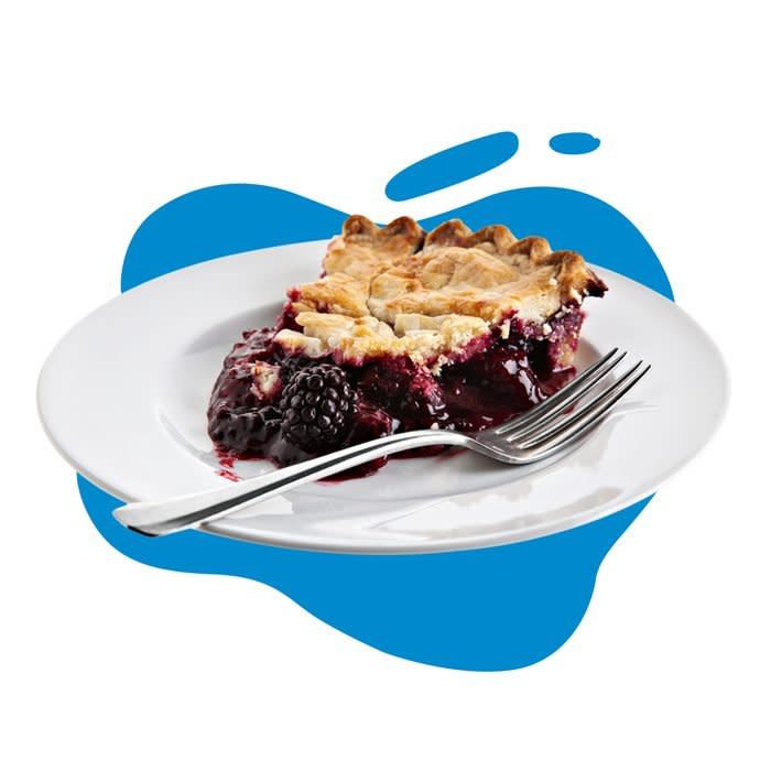 A blackberry pie slice on a white plate with a fork on a blue blob background