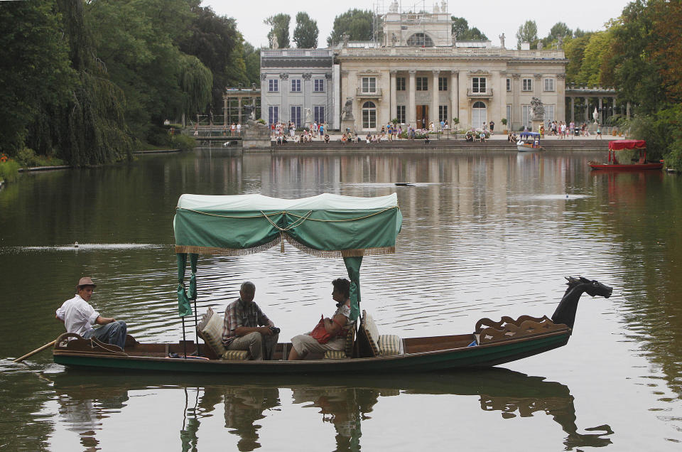 This Aug. 6, 2013 photo shows visitors taking a boat ride on a pond in front of the Palace on the Isle in the Lazienki Park in Warsaw, Poland. Part of the Royal Route, the 17th century Royal Baths park is one of the most picturesque parks in Europe. There is a charge for visitors to the ornate Palace on the Isle, but you can just stroll for free in the surrounding park and gardens, around the pond. (AP Photo/Czarek Sokolowski)