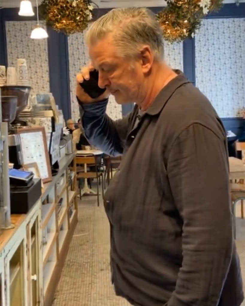 Alec Baldwin inside the coffee shop as the protester speaks to him. Twitter/CrackheadBarney&Friends