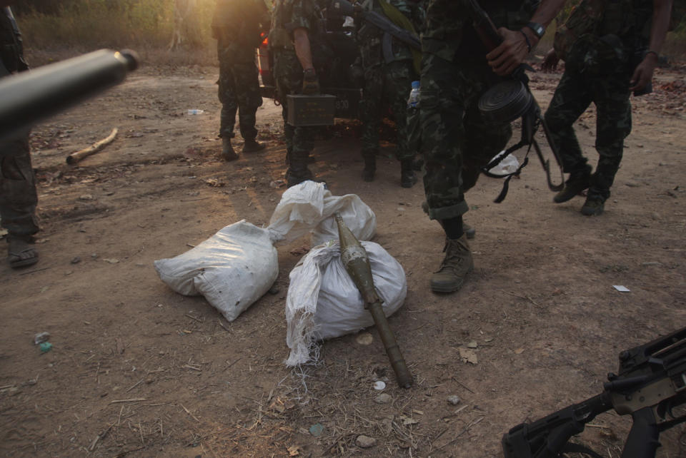 Members of the Karen National Liberation Army and People’s Defense Force collect weapons after they captured an army outpost, in the southern part of Myawaddy township in Kayin state, Myanmar, March 11, 2024. (AP Photo/METRO)