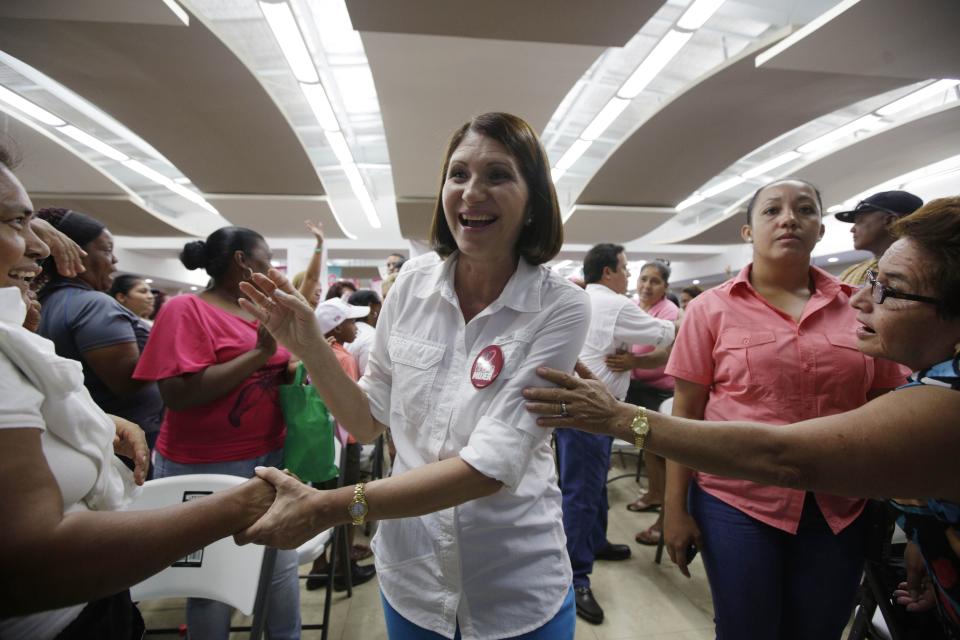 In this April 15, 2014 photo, Marta Linares, the wife of Panama's President Ricardo Martinelli, vice president candidate for the Democratic Change Party, greets women as she campaigns in Panama City. Barred by the constitution from seeking immediate re-election, President Martinelli is counting on his wife and another loyalist newcomer, presidential candidate Jose Domingo Arias, to protect his legacy for transforming Panama into one of the world’s fastest-growing economies. Panama will hold general election on May 4. (AP Photo/Arnulfo Franco)