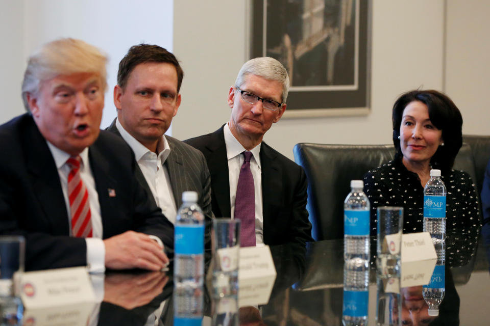 U.S. President-elect Donald Trump speaks as (2nd L to R) PayPal co-founder and Facebook board member Peter Thiel, Apple Inc CEO Tim Cook and Oracle CEO Safra Catz look on during a meeting with technology leaders at Trump Tower in New York U.S., December 14, 2016. REUTERS/Shannon Stapleton