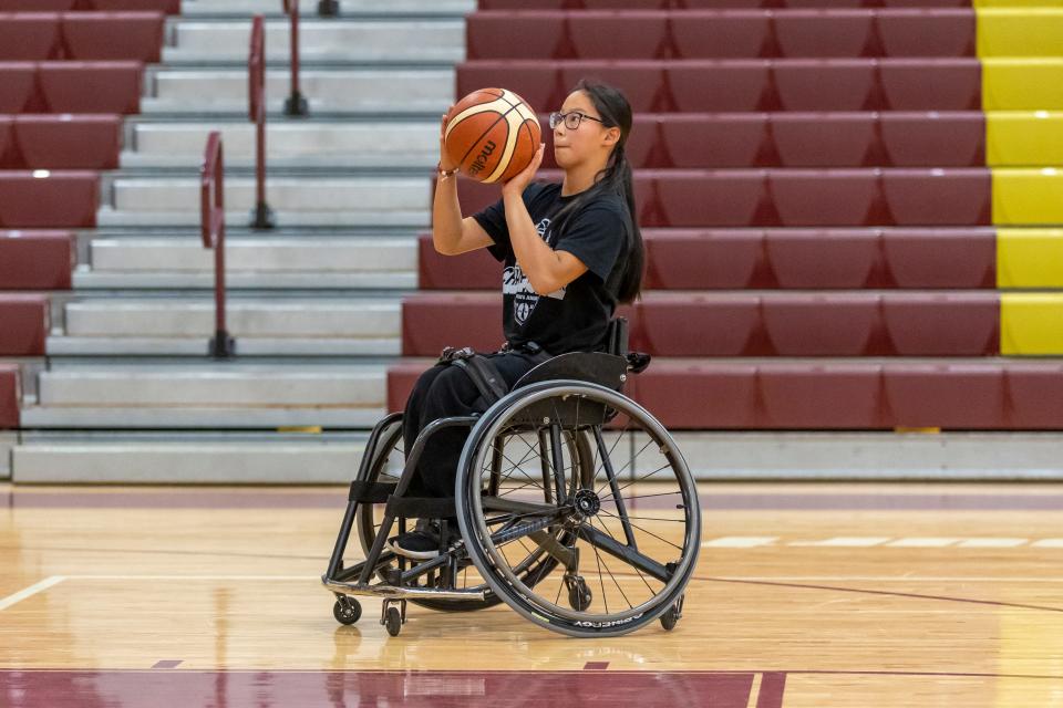 Hannah Exline, a Brebeuf Jesuit senior, plays tennis on the Braves' JV team. She got a full-ride scholarship to play wheelchair basketball at the University of Texas-Arlington.