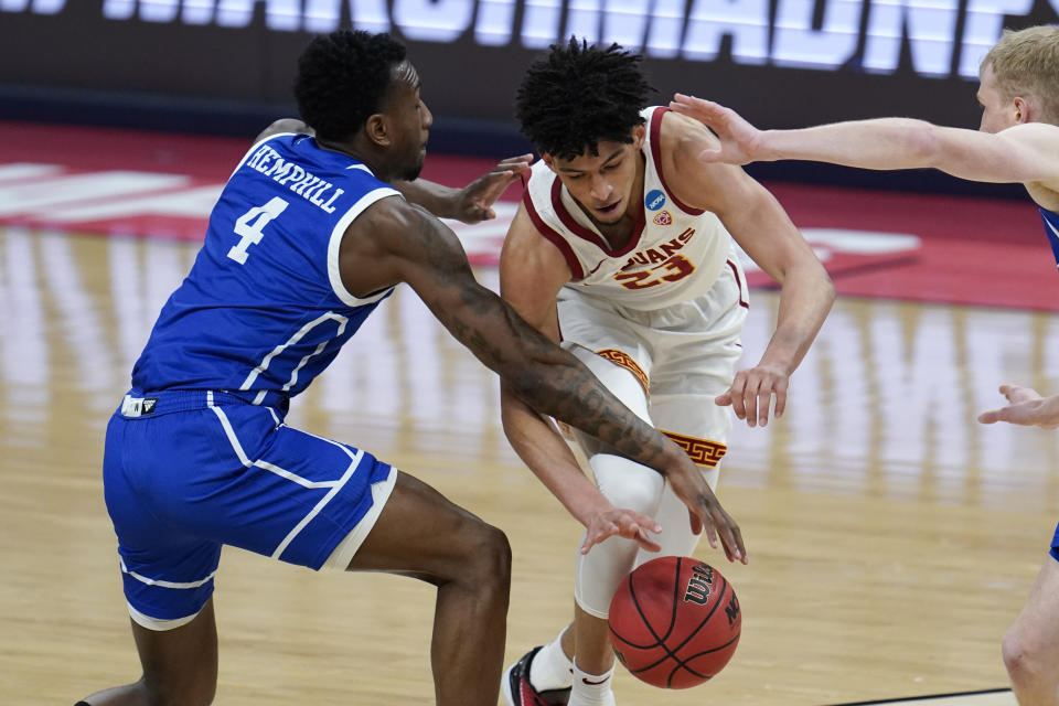 USC forward Max Agbonkpolo (23) drives on Drake forward ShanQuan Hemphill (4) during the first half of a men's college basketball game in the first round of the NCAA tournament at Bankers Life Fieldhouse in Indianapolis, Saturday, March 20, 2021. (AP Photo/Paul Sancya)