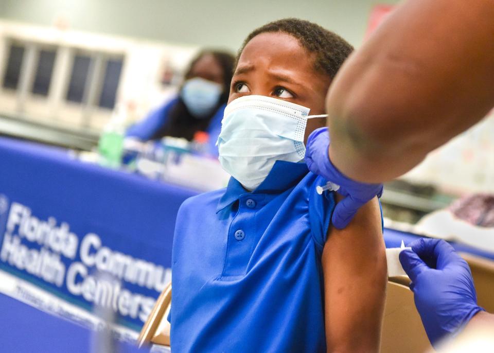 Jaheim Knight, 5, of Fort Pierce, receives his first dose of the Pfizer COVID-19 vaccine on Tuesday, Nov. 16, 2021, at Chester A. Moore Elementary School in Fort Pierce. St. Lucie Public Schools partnered with Florida Community Health Centers to host a vaccine clinic for SLPS students, families and staff.