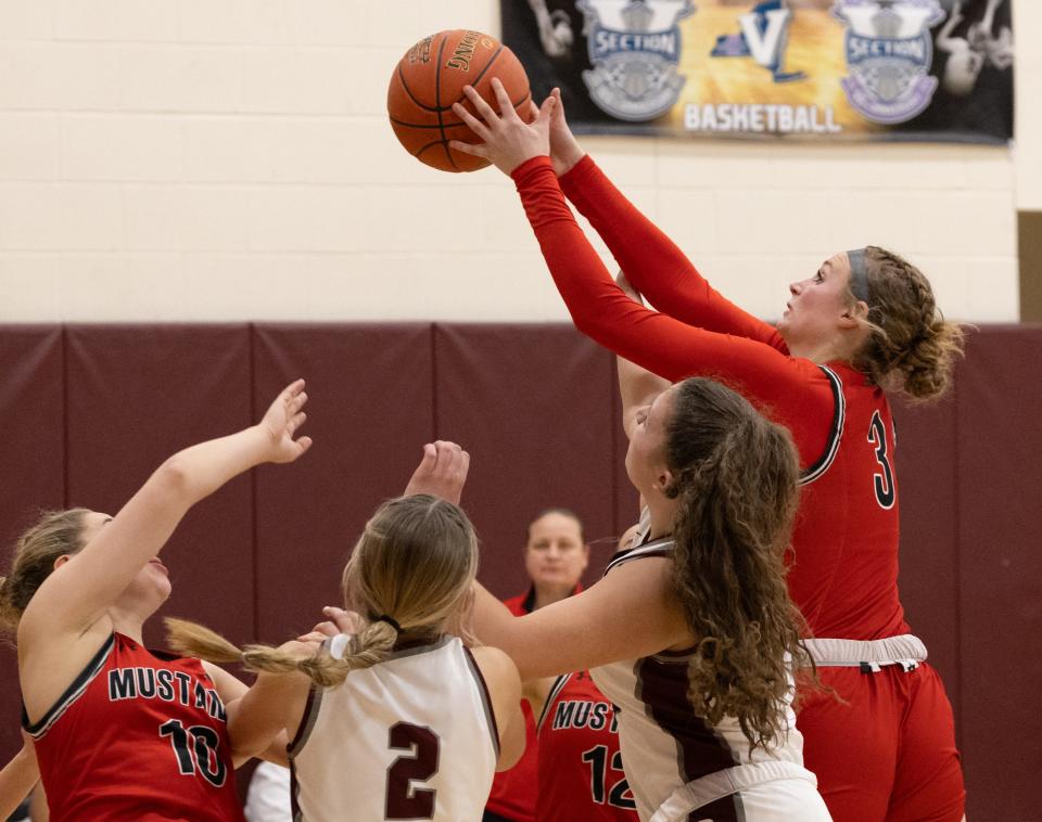 Dansville's Aynsley Belcher grabs a rebound against Caledonia-Mumford Wednesday, Jan. 17 at Caledonia-Mumford High School.