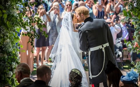 Meghan Markle and Prince Harry kiss on the steps of St George's Chapel at Windsor Castle following their wedding - Credit:  Danny Lawson/PA