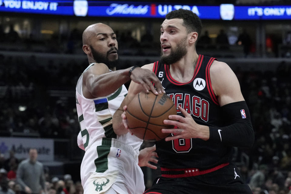 Chicago Bulls' Zach LaVine drives to the basket under pressure from Milwaukee Bucks' Jevon Carter during the first half of an NBA basketball game Thursday, Feb. 16, 2023, in Chicago. (AP Photo/Charles Rex Arbogast)