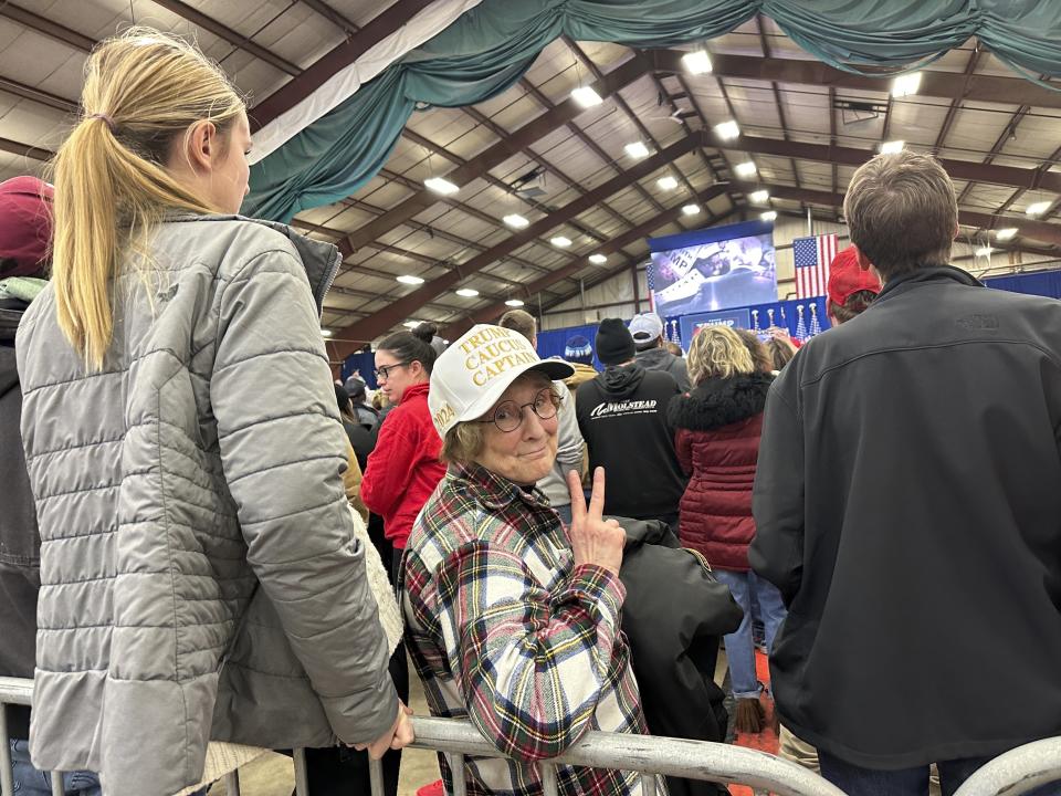 Jackie Garlock, of Clear Lake, Iowa, wears a white hat indicating her status as one of Donald Trump's "caucus captains" while attending his rally in Mason City, Iowa, on Friday, Jan. 5, 2024. She says she's not particularly good at political organizing but has confidence Trump will win the Republican caucuses on Jan. 15. (AP Photo/Steve Peoples)