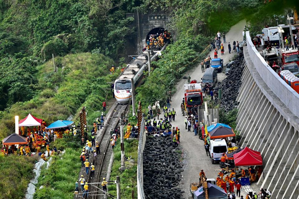 This photo shows rescue workers at the site where a train derailed inside a tunnel in the mountains of Hualien, eastern Taiwan on April 2, 2021. (Photo by Sam Yeh / AFP) (Photo by SAM YEH/AFP via Getty Images)