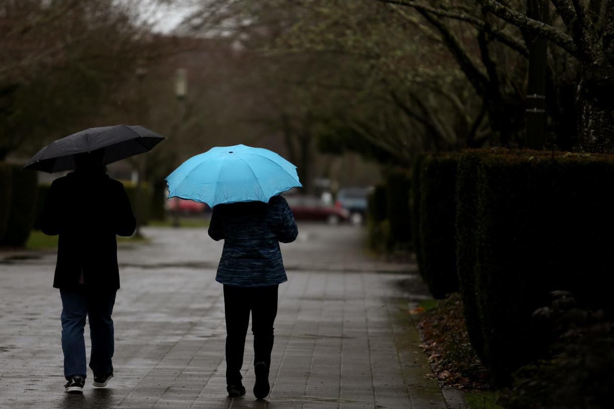 People walk with umbrellas as rain falls in Salem in 2019. Another round of heavy rainfall will hit Oregon over the next few days, but it’s probably not enough to bring flooding, said National Weather Service meteorologists.
