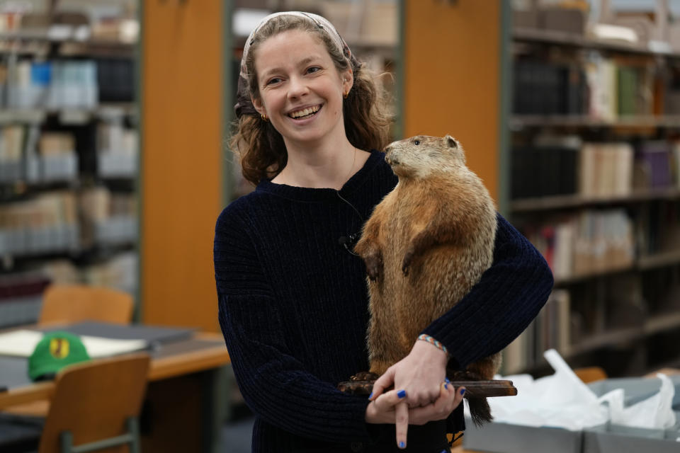 Anthropologist Sarah Edris with the Pennsylvania German Cultural Heritage Center holds a taxidermy mascot of Groundhog Lodge Number 1 during an interview in Kutztown, Pa., Monday, Jan. 29, 2024. These lodges began as a way to preserve and celebrate Pennsylvania Dutch culture and traditions. (AP Photo/Matt Rourke)