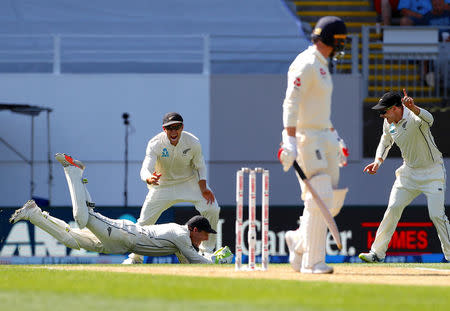 Cricket - Test Match - New Zealand v England - Eden Park, Auckland, New Zealand, March 22, 2018. England's Dawid Malan watches as New Zealand's wicketkeeper Bradley-John Watling dives to take a catch to dimiss him during the first day of the first cricket test match. REUTERS/David Gray