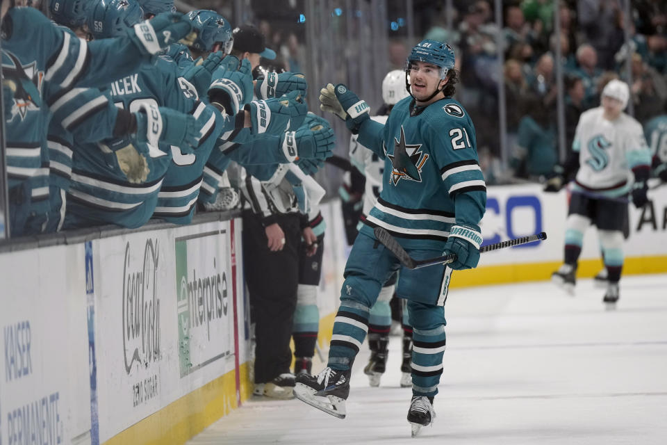 San Jose Sharks center Michael Eyssimont (21) is congratulated by teammates after scoring against the Seattle Kraken during the third period of an NHL hockey game in San Jose, Calif., Monday, Feb. 20, 2023. (AP Photo/Jeff Chiu)