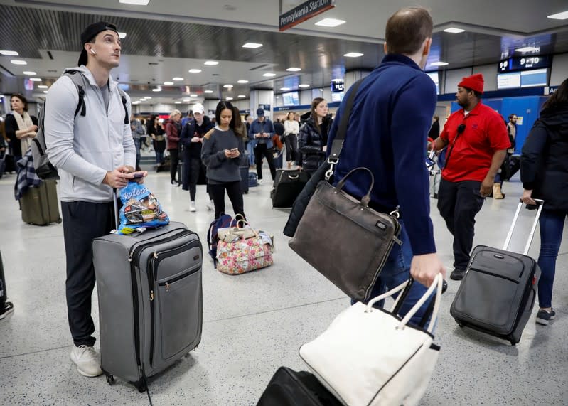 Travelers wait in the boarding area for trains during the Thanksgiving holiday travel rush at Pennsylvania Station in New York