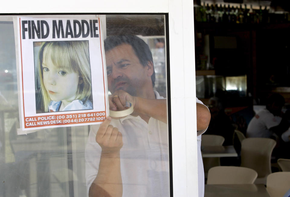 FILE - A waiter displays a picture of missing 3-year-old girl Madeleine McCann on a restaurant's window, Thursday, May 10 2007, in Praia da Luz, southern Portugal. A man who is also a suspect in the disappearance of British toddler Madeleine McCann goes on trial Friday, Feb. 16, 2024 over several sexual offenses he is alleged to have committed in Portugal between 2000 and 2017. (AP Photo/Armando Franca, File)