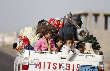 Children ride on the back of a pick-up truck with their luggage as they flee Saudi-led air strikes in Sanaa, Yemen, April 6, 2015. REUTERS/Khaled Abdullah