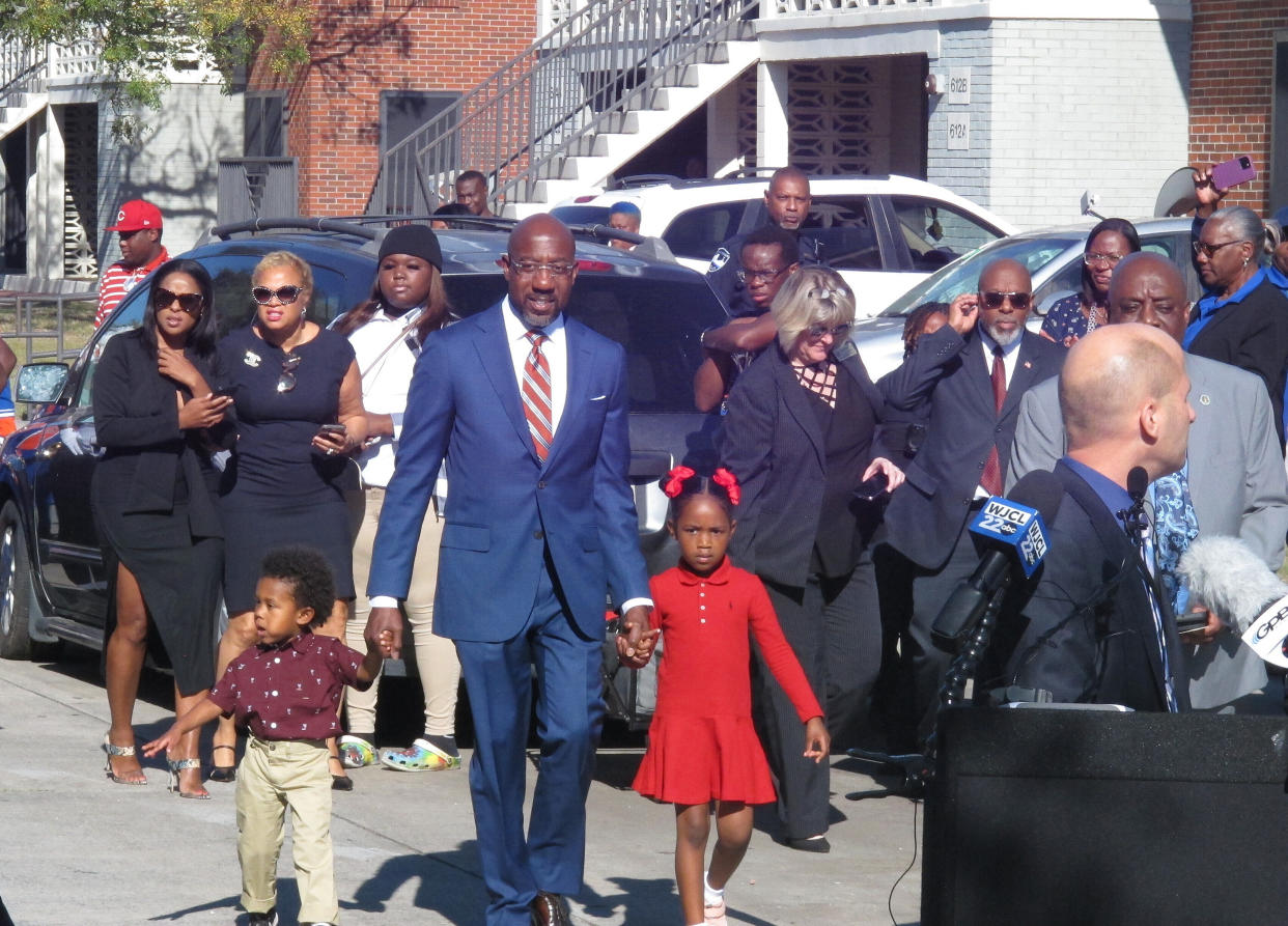 Sen. Raphael Warnock with his son, Caleb, left, and his daughter, Chloe
