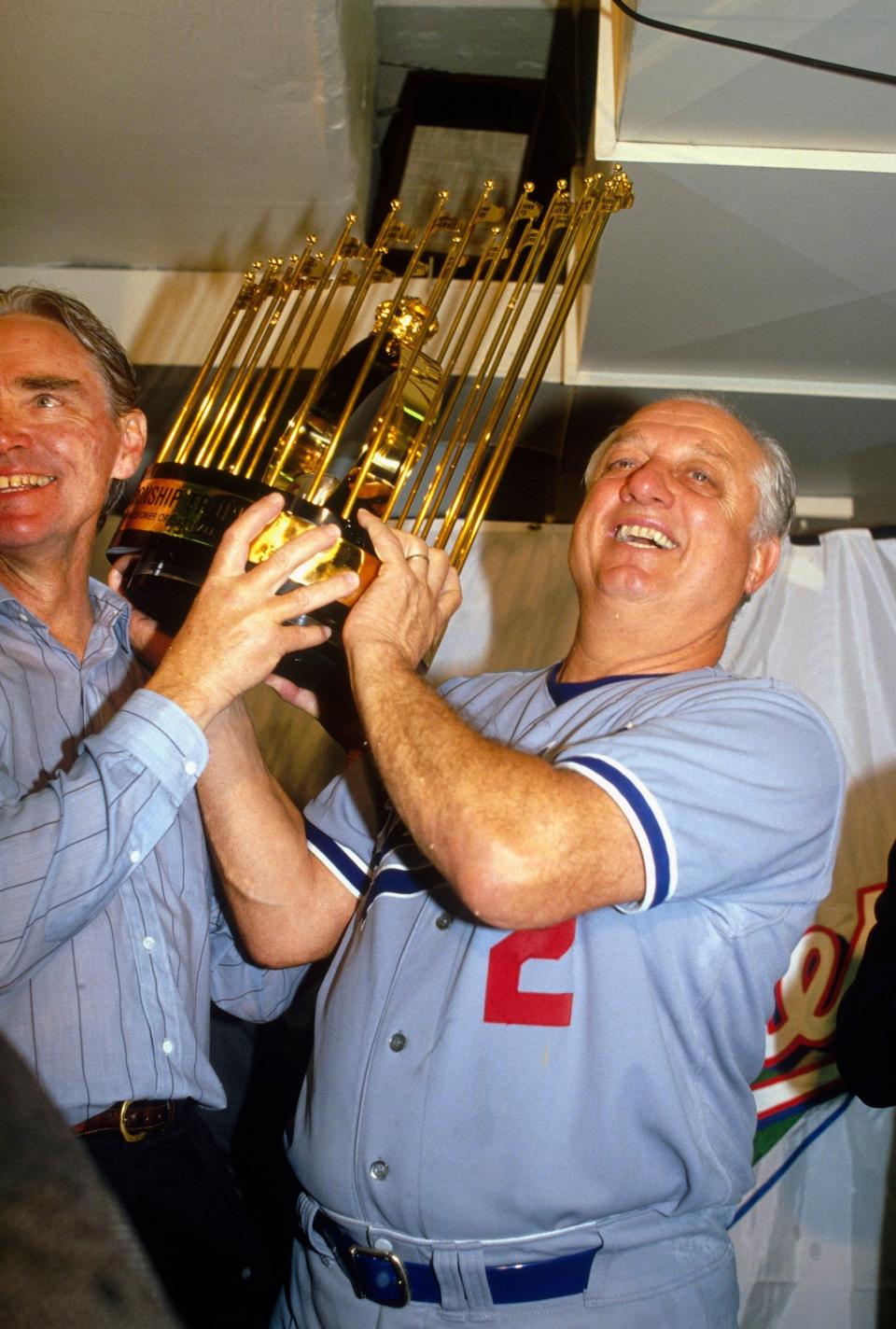 With the Dodgers' general manager Fred Claire, lifting the World Series trophy after beating Oakland Athletics in 1988 - Focus on Sport via Getty Images