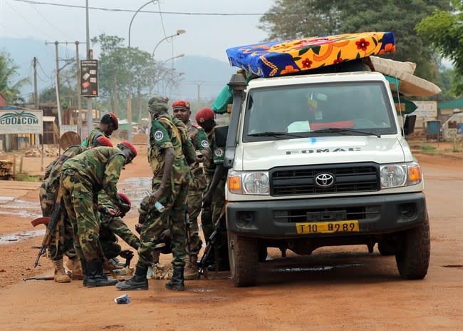 Chadian troops within the FOMAC forces reload their weapons as they leave the area next to the airport in Bangui, Central African Republic, Tuesday Dec. 10, 2013. Two French soldiers were killed in combat in Central African Republic's capital, the first French casualties since French President Francois Holland ordered a stepped-up military presence in the restive former colony to help quell inter-religious violence. (AP Photo/Jerome Delay)