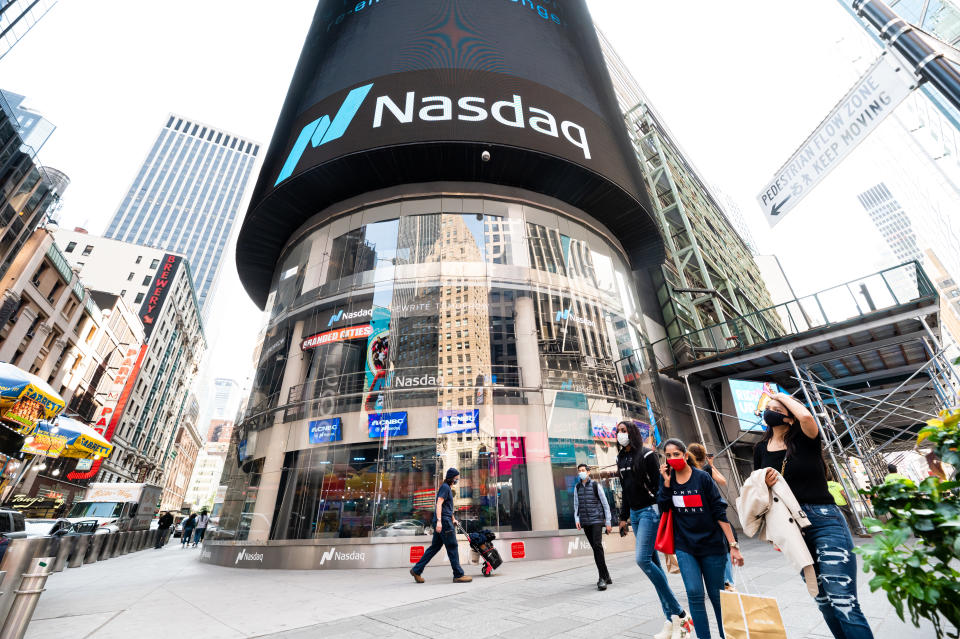 NEW YORK, NEW YORK - SEPTEMBER 22:  People wear protective face masks outside Nasdaq in Times Square as the city continues Phase 4 of re-opening following restrictions imposed to slow the spread of coronavirus on September 22, 2020 in New York City. The fourth phase allows outdoor arts and entertainment, sporting events without fans and media production. (Photo by Noam Galai/Getty Images)