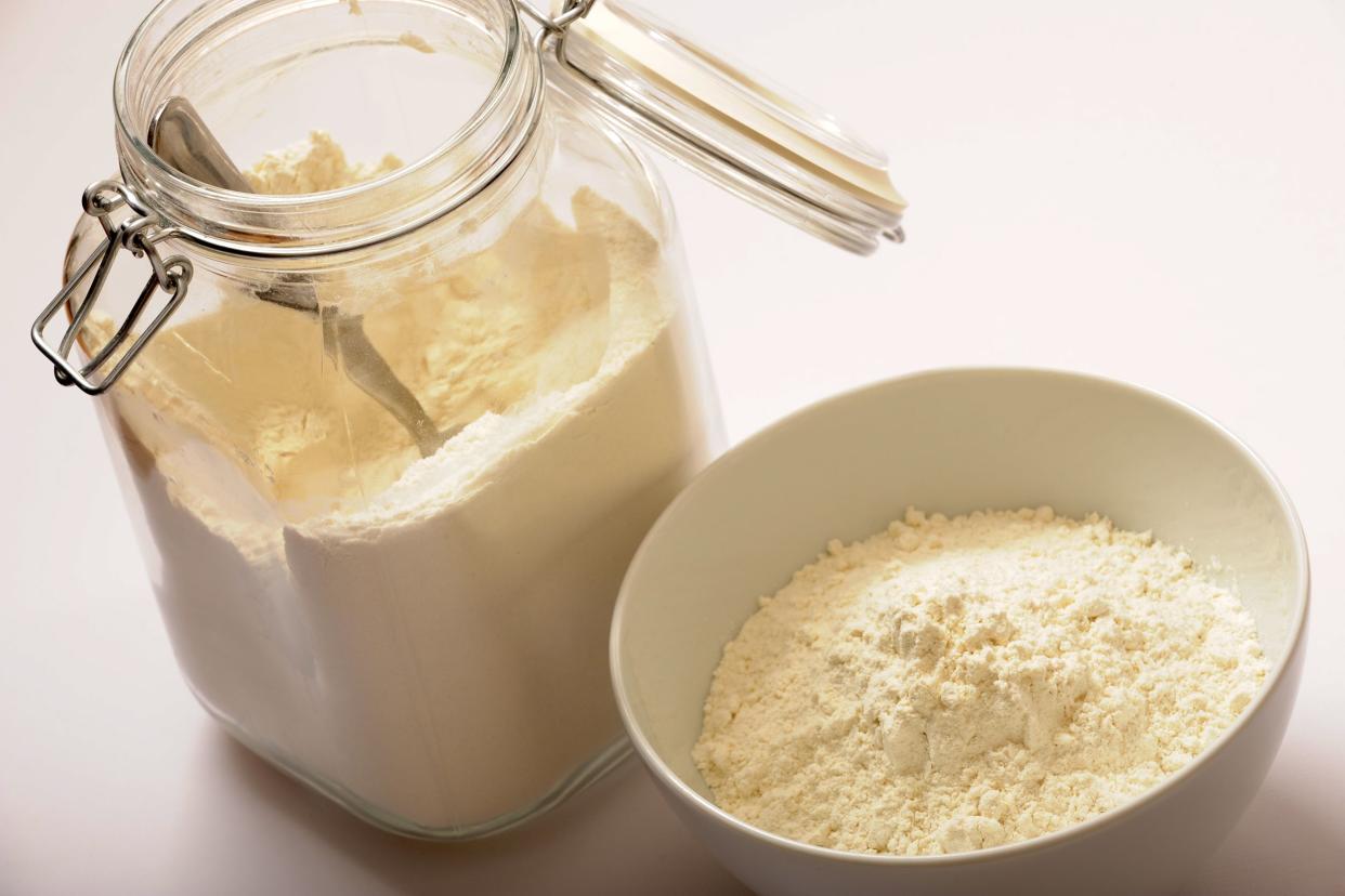 Flour in a glass jar next to a bowl