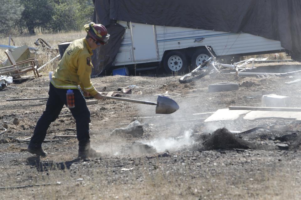 Firefighters mop up on Friday, July 15, 2022, a day after the Peter Fire destroyed a dozen homes as it tore through 304 acres outside Anderson.