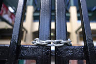 The gate to Roger Dean Stadium is locked as Major League Baseball negotiations continue in an attempt to reach an agreement to salvage March 31 openers and a 162-game season, Monday, Feb. 28, 2022, in Jupiter, Fla. (AP Photo/Lynne Sladky)