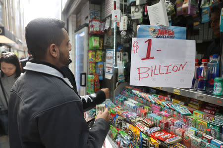 Customers line up to buy Mega Millions tickets at a newsstand in midtown Manhattan in New York, U.S., October 19, 2018. REUTERS/Mike Sugar