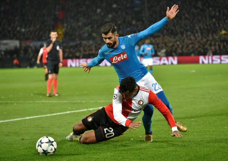 Feyenoord's Renato Tapia (L) vies for the ball with Napoli's Elseid Hysaj during their match at the Feyenoord Stadium in Rotterdam on December 6, 2017