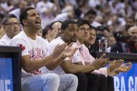 Rapper Drake, left, reacts during the Toronto Raptors 94-87 loss to the Brooklyn Nets in Game 1 of an opening-round NBA basketball playoff series, in Toronto on Saturday, April 19, 2014. (AP Photo/The Canadian Press, Chris Young)