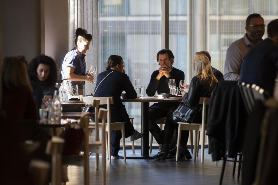 In this Tuesday, Nov. 26, 2019, photo shows a server waiting on a table at the Wolf, by Chef Ethan Stowell, restaurant at the Nordstrom NYC Flagship in New York. Millennials and Generation Z accounted for 47% of luxury consumers in 2018 and for 33% of all luxury sales worldwide in 2018, according to a study by consulting firm Bain & Co. Together, however, they contributed to virtually all of the market's growth, compared with 85% in 2017. (AP Photo/Mary Altaffer)