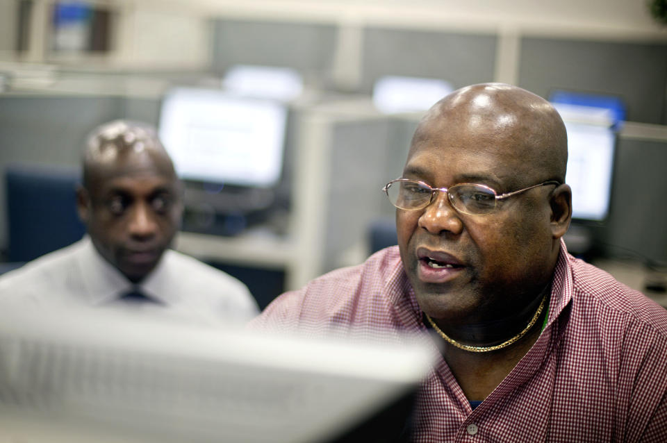 In a Monday, July 2, 2012 photo, Army veteran Chester Dixon, right, works with William Moore, Georgia Department of Labor veterans representative, to apply for a a new skills-based program to get out-of-work veterans trained and back in the job market in Atlanta. The program is first-come, first-serve for qualifying veterans between the ages of 35 and 60 who are unemployed at the time of the application. Veterans who do qualify can receive up to 12 months of education assistance in high demand areas like science and technology. (AP Photo/David Goldman)