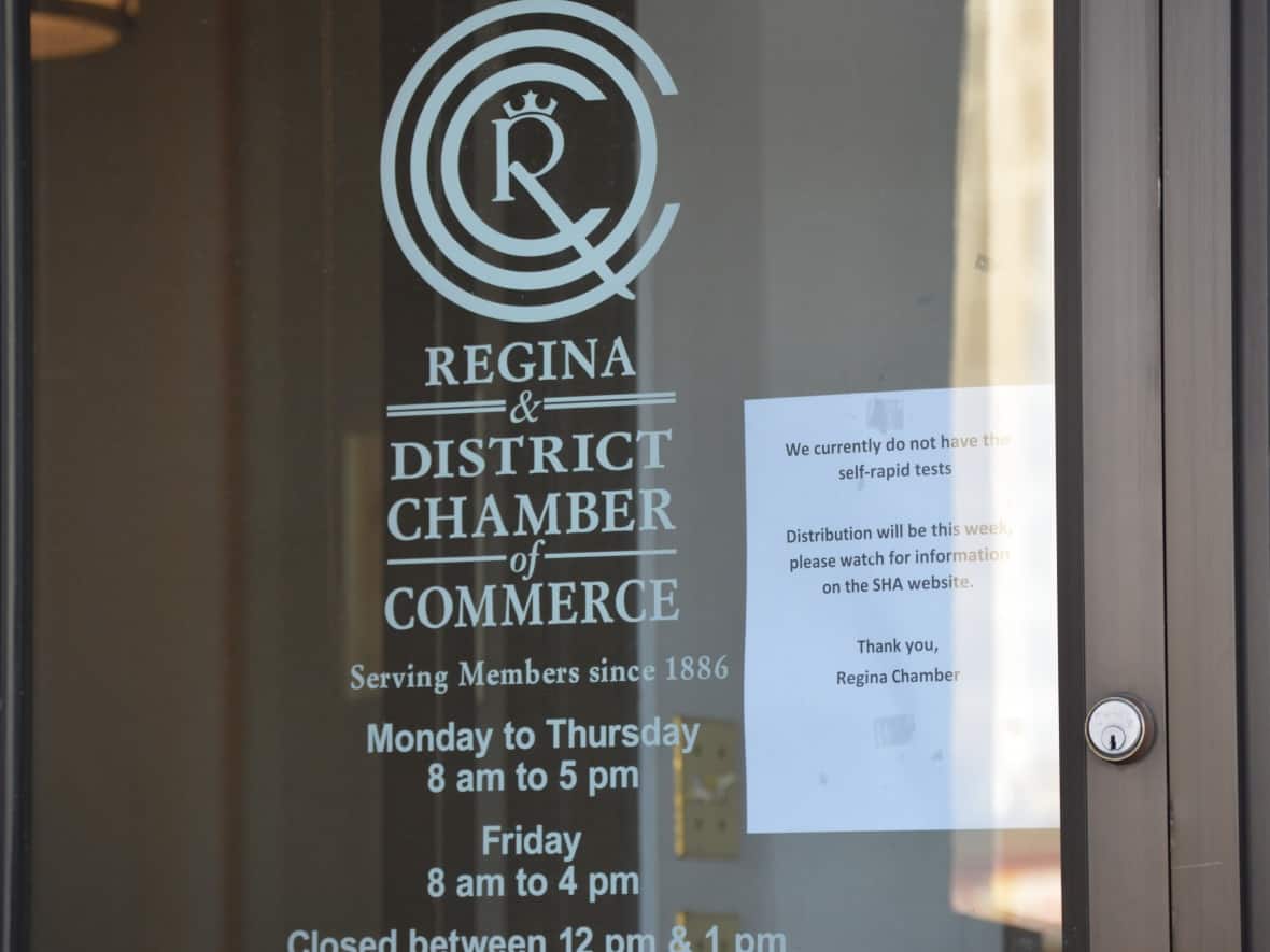 A sign on the door of the Regina & District Chamber of Commerce informs visitors that no rapid test kits were available there on Monday, Oct. 18. A limited number of self-testing kits were expected to be available Friday at the Chamber of Commerce office in Swift Current and at the chamber office in Meadow Lake. (Alexander Quon/CBC - image credit)