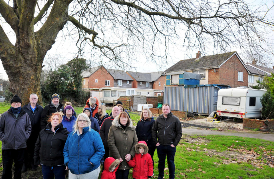 Local residents in front of the shipping container which has been put in the front garden of a house in Swindon. See SWNS story SWBRcaravan. A star of ''My Nightmare Neighbour Next Door'' who lives in a run down caravan outside her house is finally facing legal action from a council. Lillie Goddard and her disabled mother are apparently living in the dirty static home alongside Lillie's £170,000 property. She previously had a shipping container in the garden in Swindon in Wilts - and has faced years of complaints from neighbours.  Locals say the house - and a second smaller caravan at the address - are believed to be rented out to numerous tenants.  