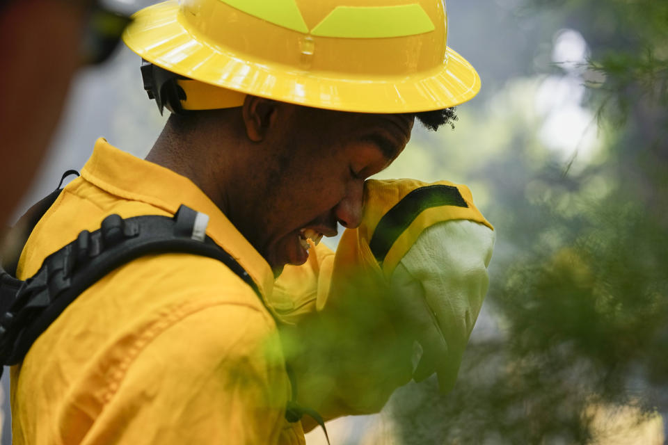 Ben Malone wipes his eyes during a wildland firefighter training Friday, June 9, 2023, in Hazel Green, Ala. A partnership between the U.S. Forest Service and four historically Black colleges and universities is opening the eyes of students of color who had never pictured themselves as fighting forest fires. (AP Photo/George Walker IV)