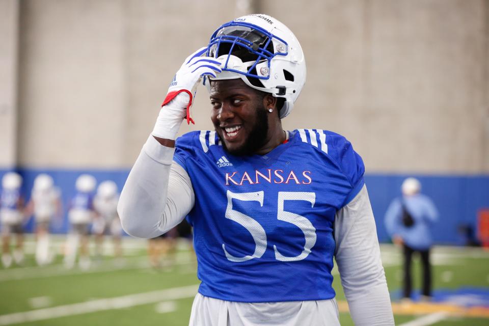 Kansas redshirt sophomore offensive lineman Ar’maj Reed-Adams (55) smiles during Tuesday’s practice inside the Kansas Indoor Practice Facility.