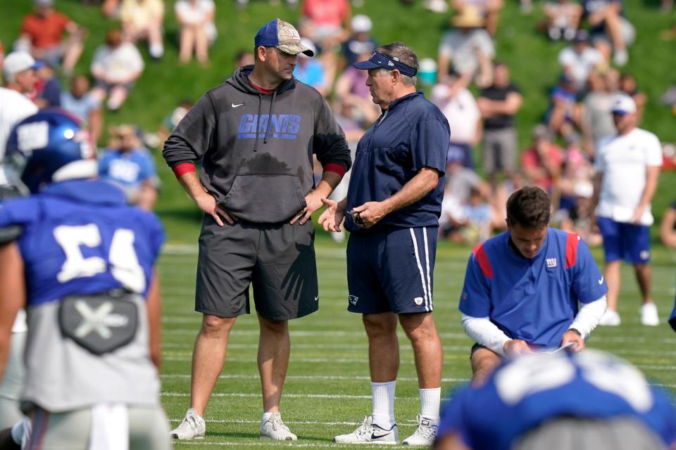 Giants head coach Joe Judge, left, and Patriots head coach Bill Belichick talk during a joint practice between the teams last August. Since Judge was fired by New York, he is available to return to New England.