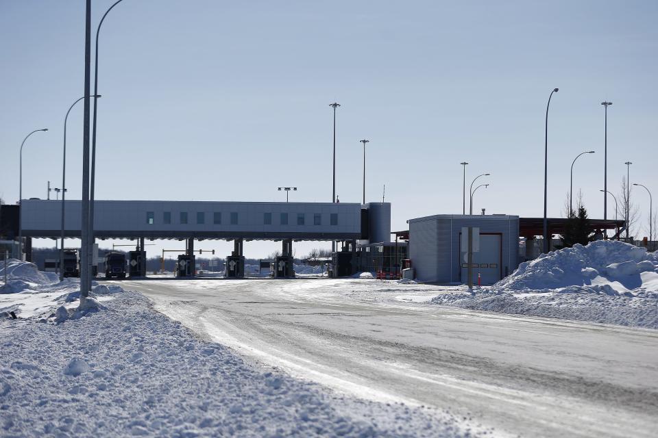 FILE- This Feb. 9, 2017, file photo shows the Canada and United States border crossing near Emerson, Manitoba. Desperate immigrants are flowing across the U.S. border into Canada. America’s neighbor to the north is increasingly being seen as a haven for asylum seekers turned away by the U.S., and are willing to chance a walk across the border in dangerous cold to get there. (John Woods/The Canadian Press via AP, File)