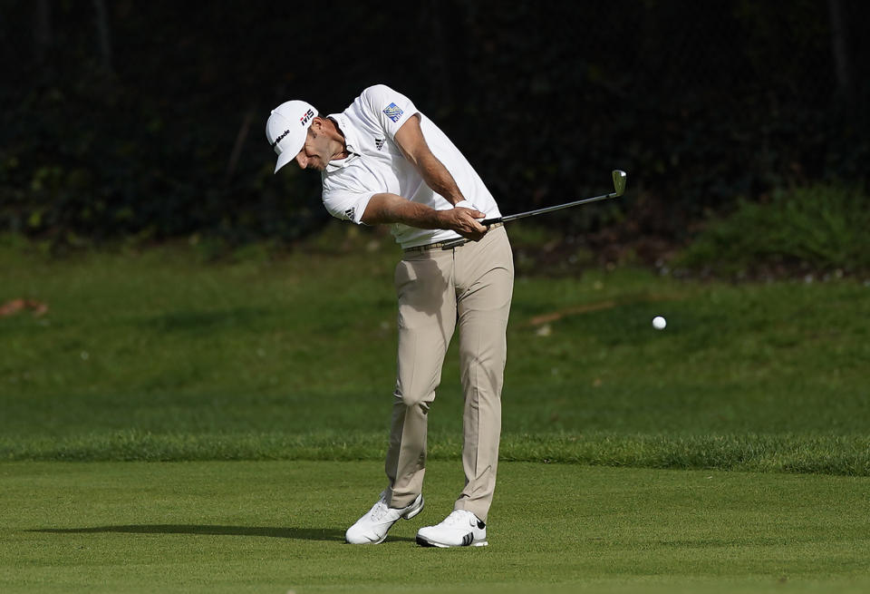 Dustin Johnson hits his second shot on the 12th hole during the first round of the Genesis Open golf tournament at Riviera Country Club, Thursday, Feb. 14, 2019, in the Pacific Palisades area of Los Angeles. (AP Photo/Ryan Kang)