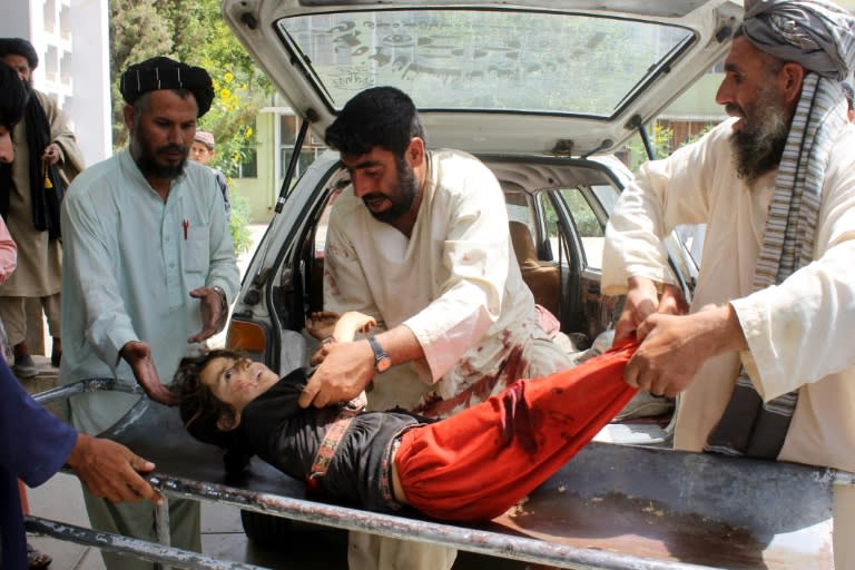 An Afghan child is brought to a hospital after being injured in a mortar explosion in Kandahar on July 1, 2015