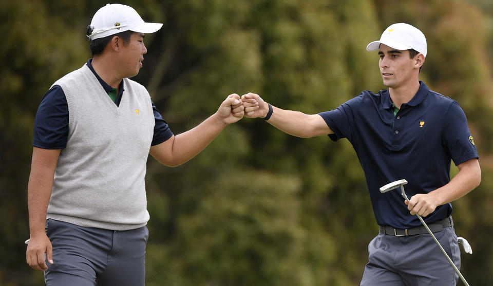 International team player Byeong Hun An of South Korea, left, and playing partner Joaquin Niemann of Chile celebrate on the 12th green in their foursome match during the President's Cup golf tournament at Royal Melbourne Golf Club in Melbourne, Saturday, Dec. 14, 2019. (AP Photo/Andy Brownbill)