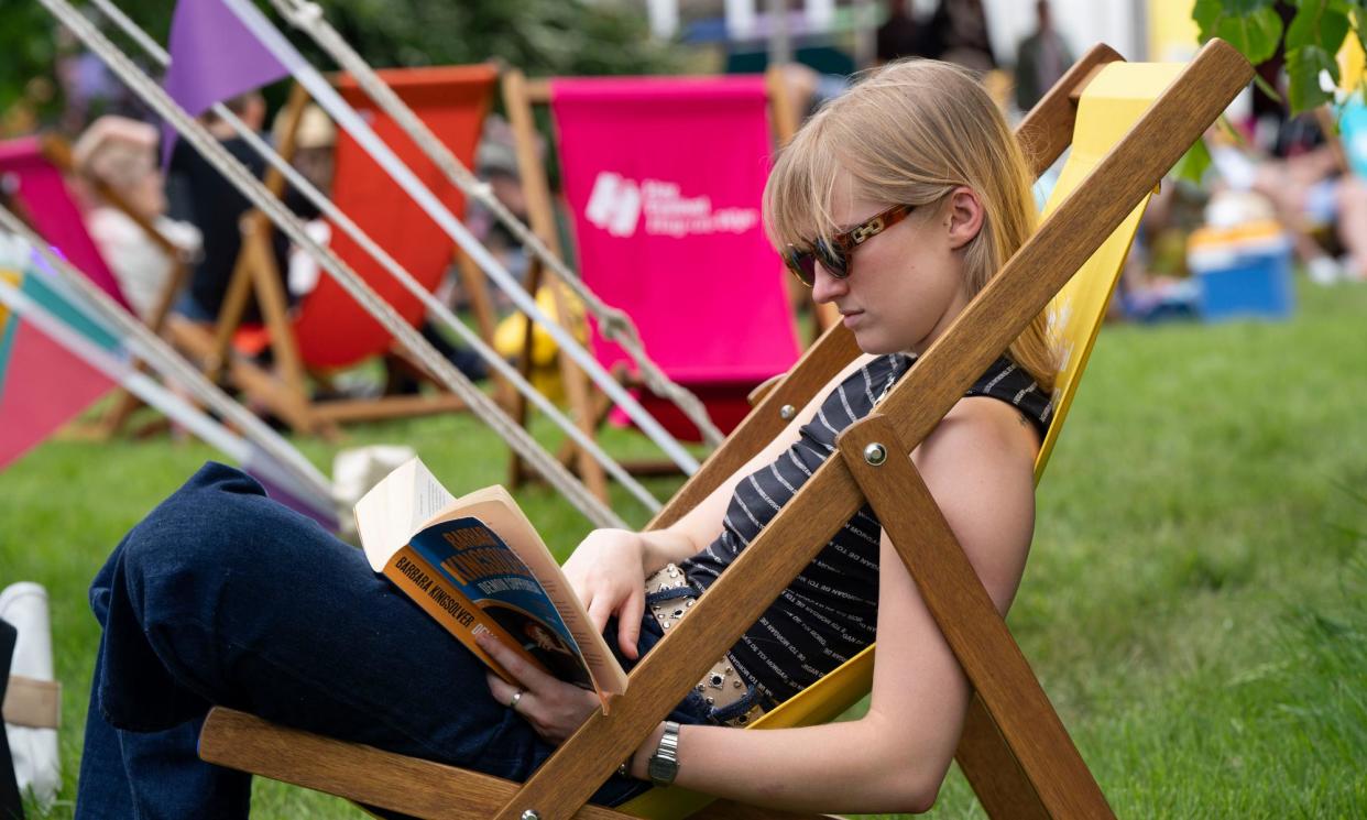 <span>A woman reading at the Hay literature festival. Hay dropped Baillie Gifford after performers pulled out of the festival.</span><span>Photograph: David Levenson/Getty</span>