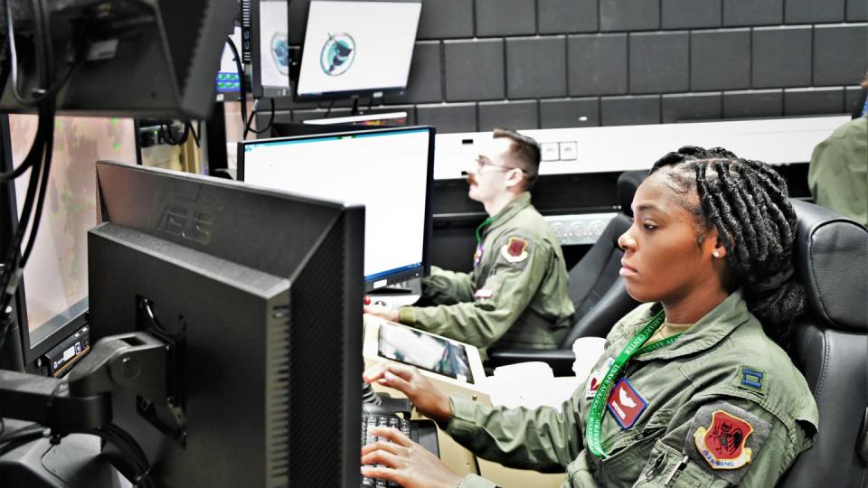 Capt. Quin’Shay Perkins, right, an MQ-9 pilot, trains on a simulator at Einsiedlerhof Air Station, Germany, on July 25, 2023. (Capt. Jered Trujillo/U.S. Air Force)