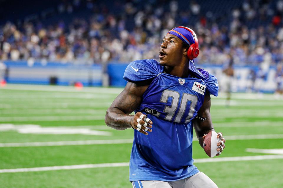 Lions running back Jamaal Williams tosses up a signed football to fans after open practice at Family Fest at Ford Field on Saturday.