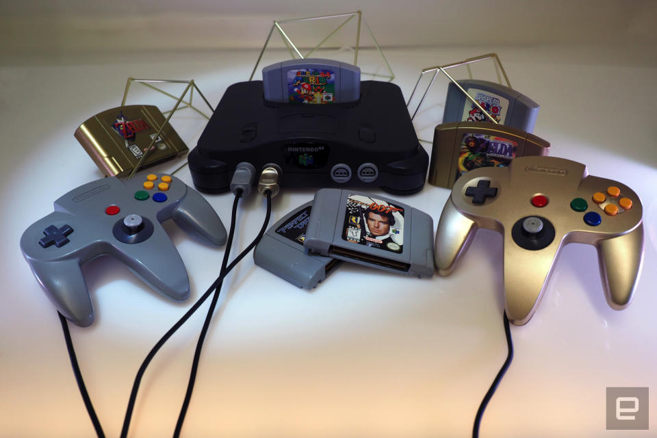 <p>Nintendo 64 on a white table with games</p>
